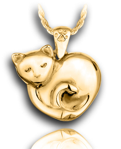 A gold pendant of a sleeping kitten curled up in a heart shape with a tiny paw print on the bail for the chain.