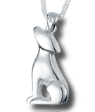 A silver pendant in the shape of a puppy sitting with its chin up, attached to a bail with a tiny paw print.