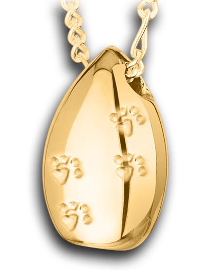 A Gold tear drop-shaped pendant with paw prints design, attached to a chain.
