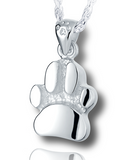 A silver, slightly curved paw print pendant with a textured background and a small paw print on the bail.